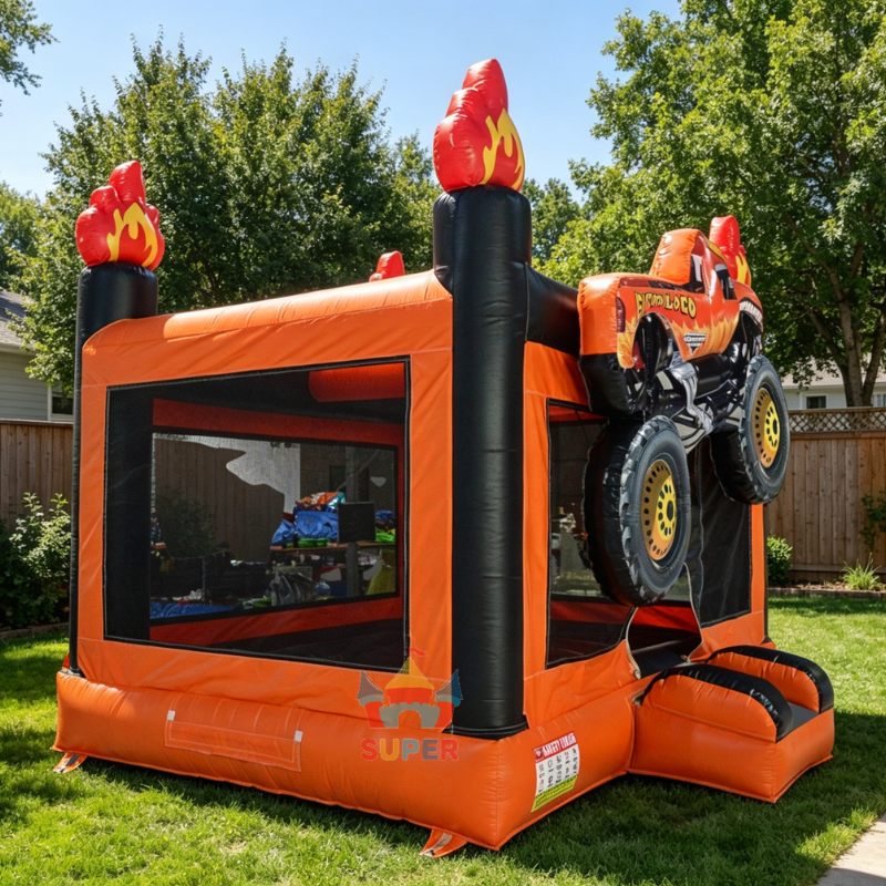 Monster truck bounce house set up outdoors on grass